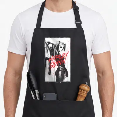 Inked vehicle apron - Grayscale Harley Quinn portrait with red HARLEY QUINN text and splatters in a white frame — shown on a black cotton canvas apron against a white background