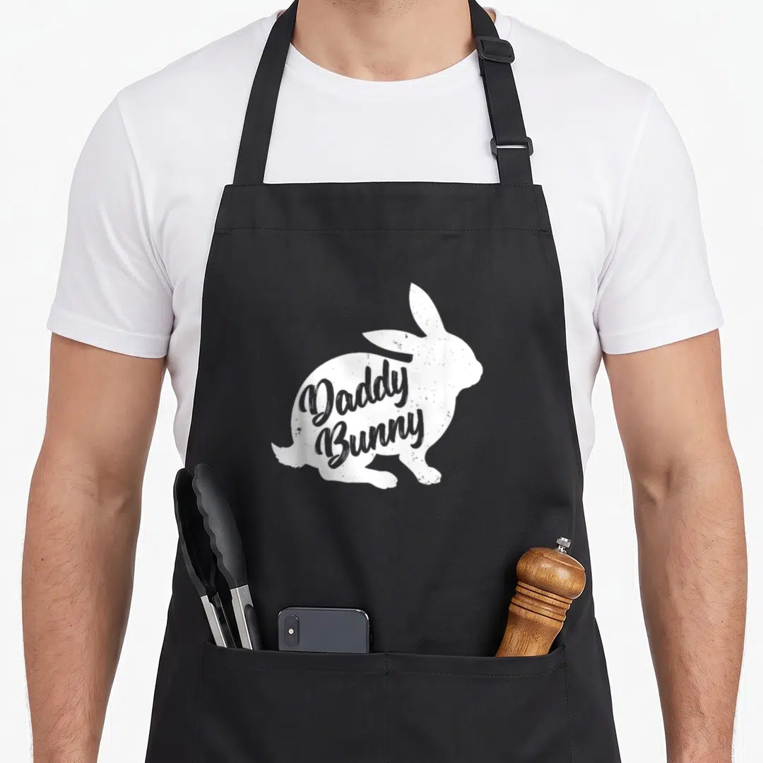 Father easter bunny aprons - White distressed rabbit silhouette with grey Daddy Bunny text inside — shown on a black cotton canvas apron against a white background