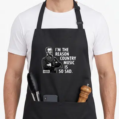 General cook's country aprons - Black and white portrait of General Sherman with white text reading I'm the reason — shown on a black cotton canvas apron against a white background
