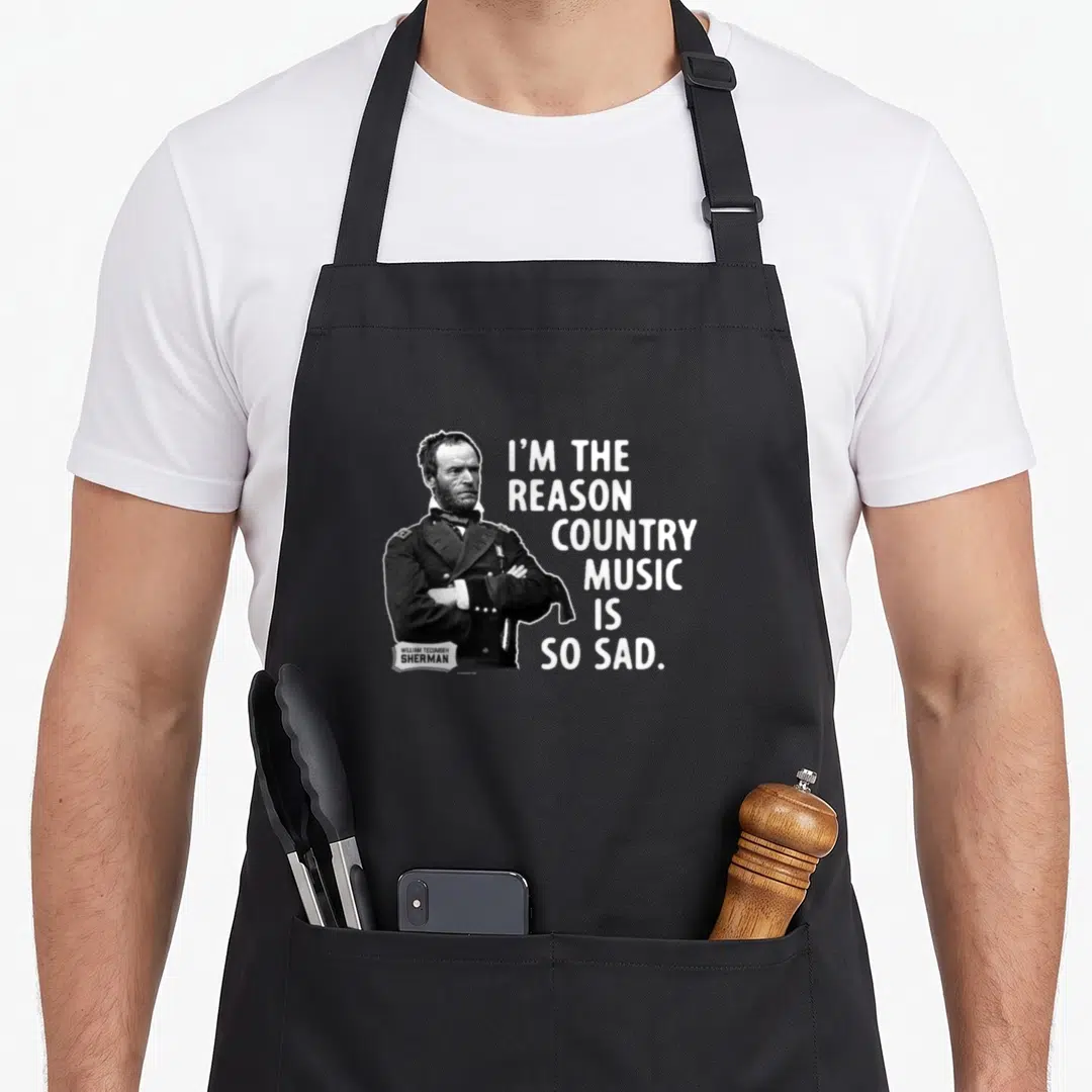 General cook's country aprons - Black and white portrait of General Sherman with white text reading I'm the reason — shown on a black cotton canvas apron against a white background
