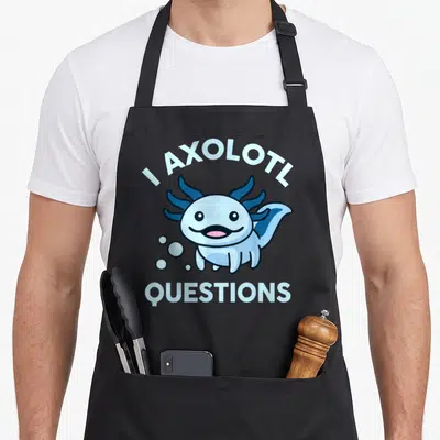 Axolotl questions apron for women - Cartoon light blue axolotl with pink tongue and bubbles beneath arching text — shown on a black cotton canvas apron against a white background