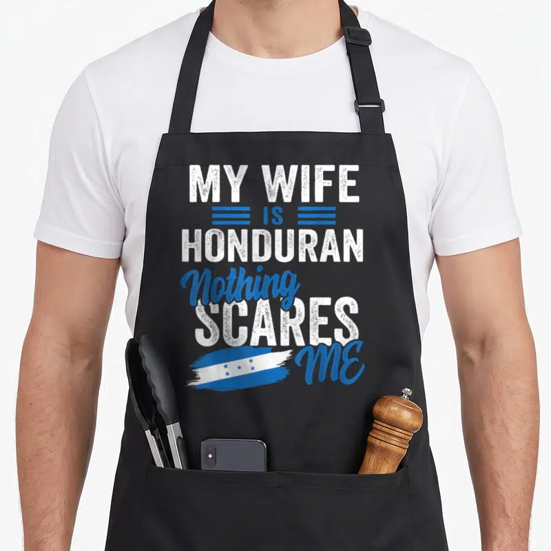 Honduras wife apron - Stacked white and blue text My Wife Is Honduran Nothing Scares Me with flag graphic — shown on a black cotton canvas apron against a white background