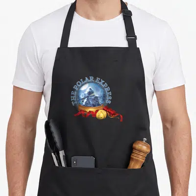 Polar express apron - Snow globe with train, blue text, gold bell, and red ribbon — shown on a black cotton canvas apron against a white background
