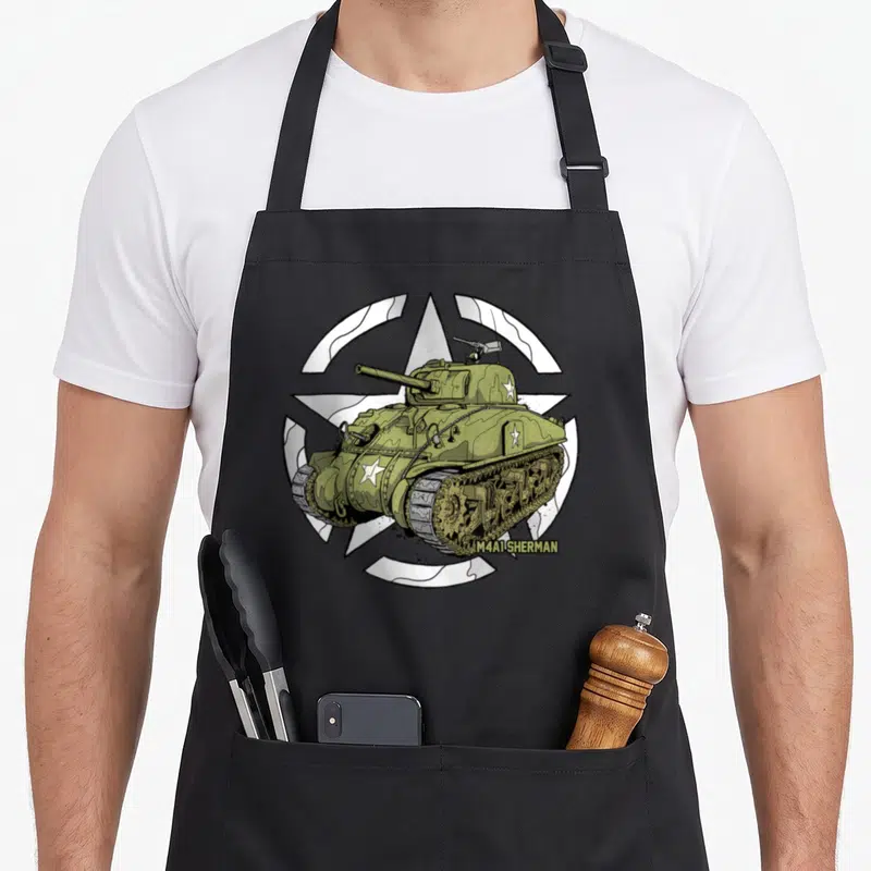 Sherman patch apron - Olive green tank illustration over white star with M4A1 SHERMAN text — shown on a black cotton canvas apron against a white background