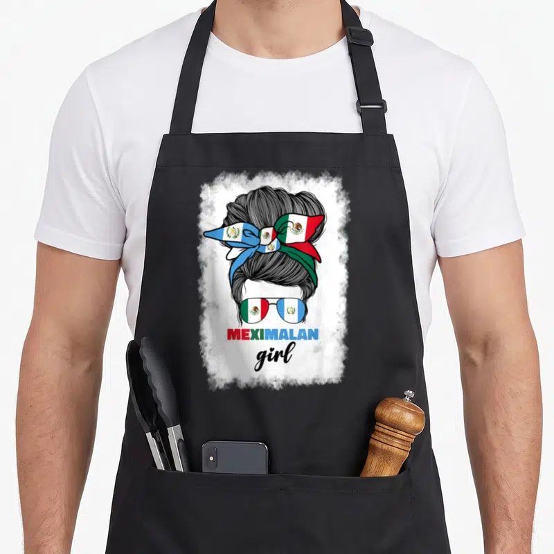 Mexico guatemala mexican apron - Cartoon woman bun with flag ribbon and MEXIMALAN girl text — shown on a black cotton canvas apron against a white background