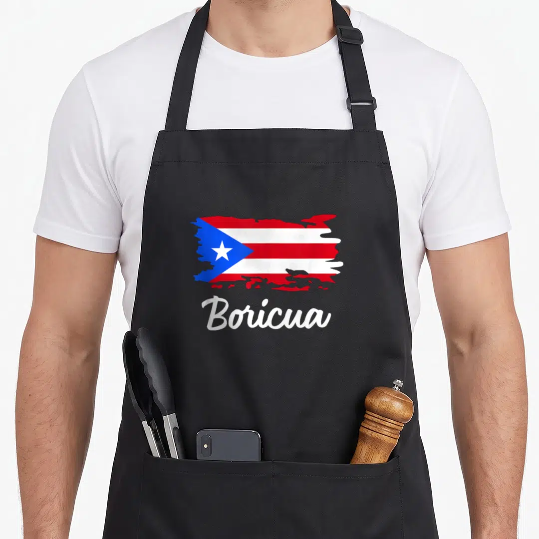 Puerto ricotta apron - Brushstroke style Puerto Rico flag in red white blue above white script text Boricua — shown on a black cotton canvas apron against a white background