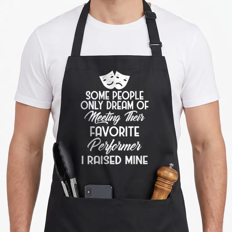 Parent people meet apron - Two white drama masks above stacked text reading Some People Only Dream of Meeting — shown on a black cotton canvas apron against a white background