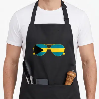 Sunglass bahamian apron - Minimalist aviator sunglasses with Bahamas flag pattern filling lenses in yellow blue — shown on a black cotton canvas apron against a white background