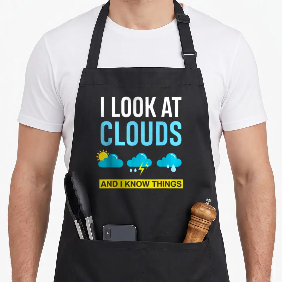 Cloud i love meteor apron - I look at clouds text with three weather icons in white blue and yellow — shown on a black cotton canvas apron against a white background