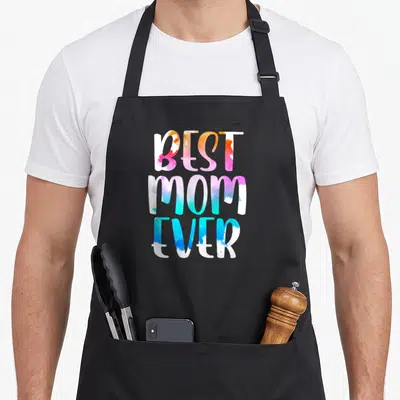 Vintage mother's day aprons - Stacked BEST MOM EVER text in watercolor orange pink blue and white — shown on a black cotton canvas apron against a white background