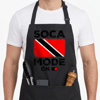Soca trinidad and tobago apron - Distressed SOCA MODE ON text with Trinidad and Tobago flag and red toggle switch — shown on a black cotton canvas apron against a white background