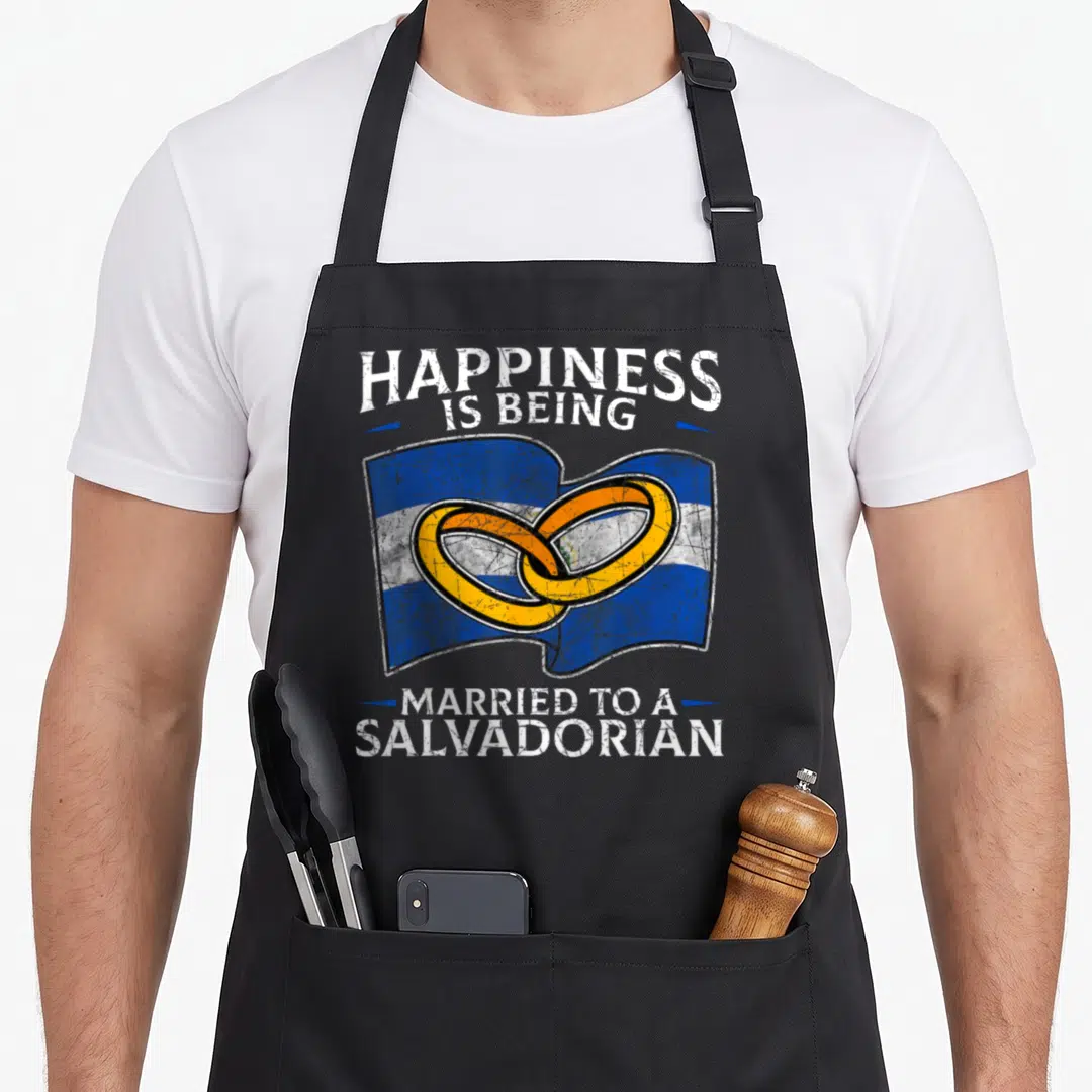 Wedding el cook apron - Waving Salvadorian flag with two gold interlocking rings and distressed white text — shown on a black cotton canvas apron against a white background