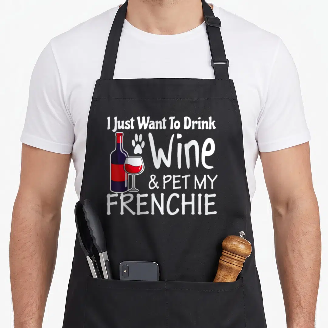 Drink french bulldog apron - Wine bottle, glass, paw print, and text reading I Just Want To Drink Wine Pet My Frenchie — shown on a black cotton canvas apron against a white background