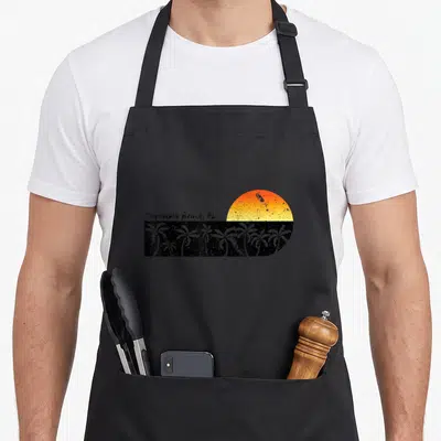Pensacola beach sunset florida apron - Retro sunset with orange sun and grey palm trees next to Pensacola Beach FL text — shown on a black cotton canvas apron against a white background