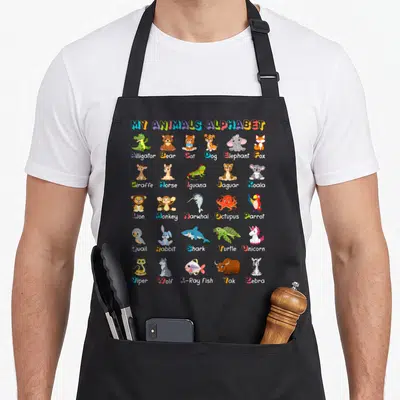 Alphabet abc animal apron - Multi-colored cartoon chart listing animals A-Z with corresponding illustrations in a grid — shown on a black cotton canvas apron against a white background