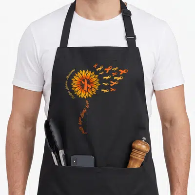 Warrior faith aprons - Sunflower with orange ribbon and text Multiple Sclerosis Awareness faith hope fight love — shown on a black cotton canvas apron against a white background
