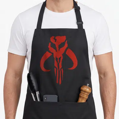 Funny lemon apron - Red stylized mythical skull symbol centered on grey background — shown on a black cotton canvas apron against a white background