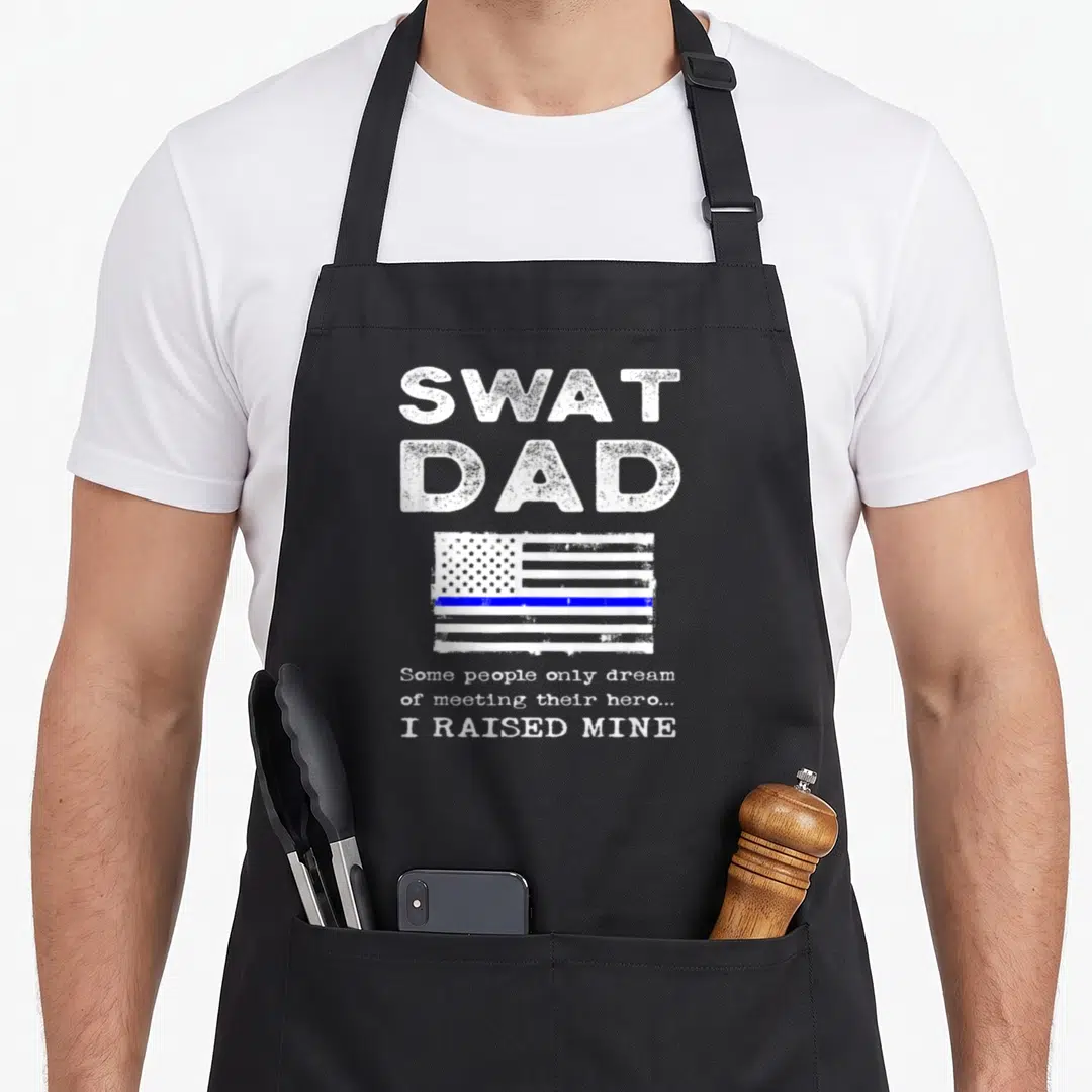 Swat special aprons - Distressed white and blue flag with SWAT DAD and Raised Mine quote text — shown on a black cotton canvas apron against a white background