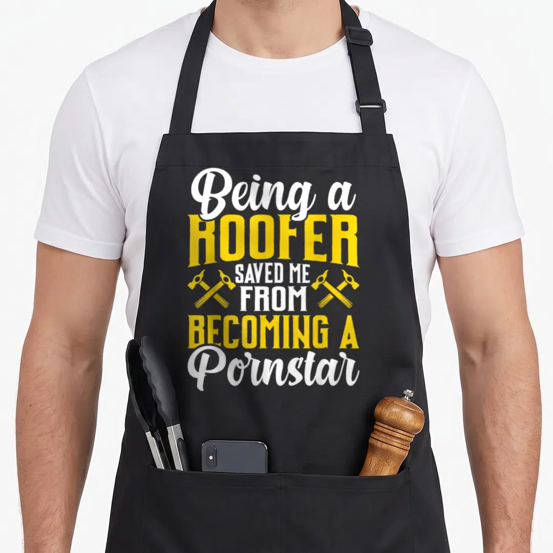 Coworker roofing apron - White and yellow text Being a ROOFER SAVED ME FROM BECOMING A Pornstar with crossed hammers — shown on a black cotton canvas apron against a white background