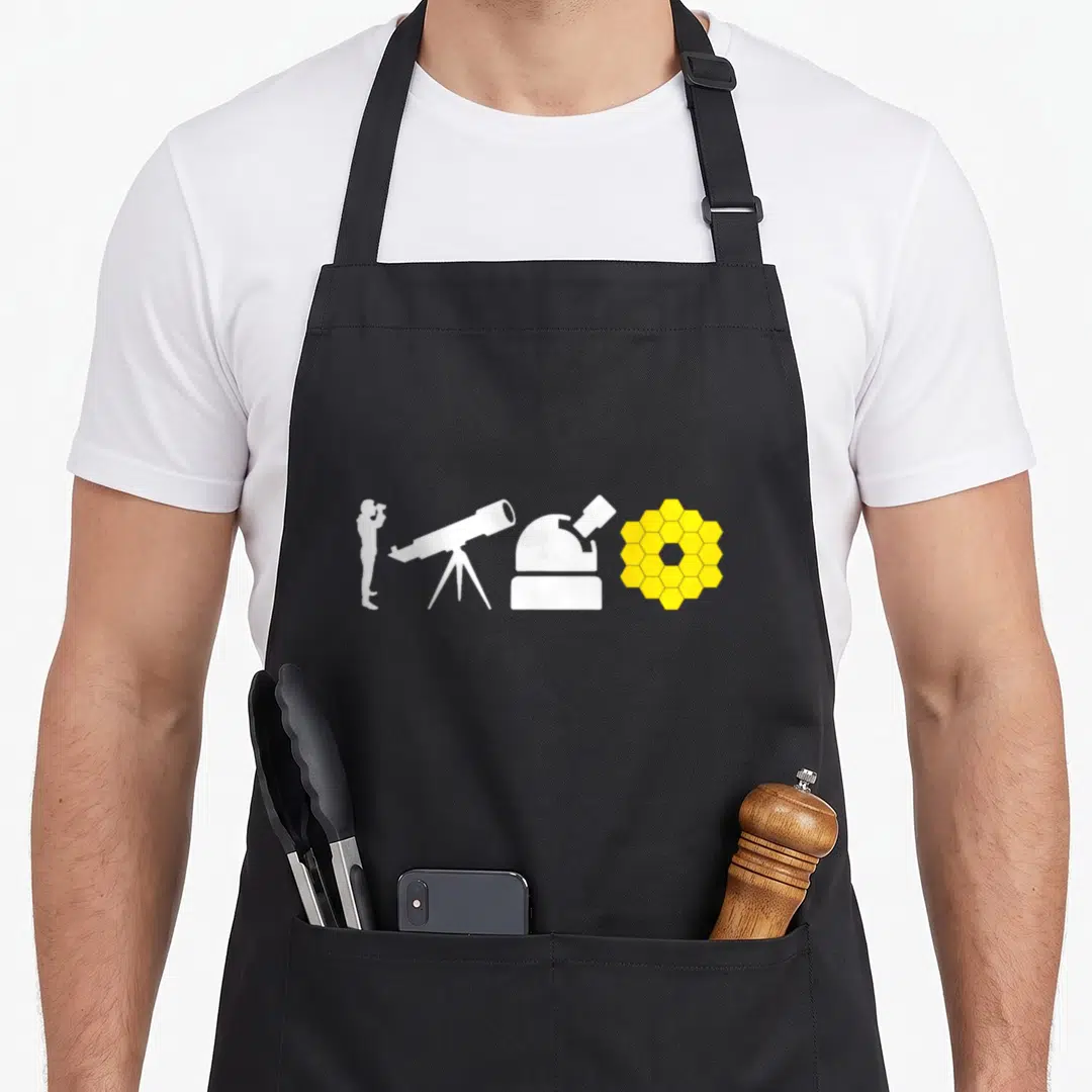 Evolution telescope apron - Four astronomy equipment silhouettes: binoculars, telescope, observatory dome, and yellow — shown on a black cotton canvas apron against a white background