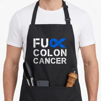 Colon cancer ribbon apron - Distressed white text FUC COLON CANCER with blue ribbon replacing K — shown on a black cotton canvas apron against a white background