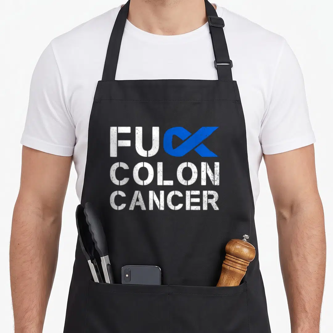 Colon cancer ribbon apron - Distressed white text FUC COLON CANCER with blue ribbon replacing K — shown on a black cotton canvas apron against a white background