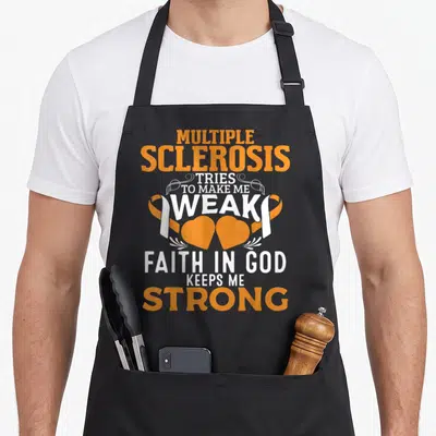 Multiple ribbon apron - Stacked orange and white text with two awareness ribbons and two hearts — shown on a black cotton canvas apron against a white background