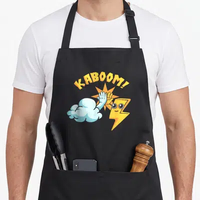 Weather thunderstorms apron - Cartoon cloud and lightning bolt high-fiving under arched yellow KABOOM! text with orange — shown on a black cotton canvas apron against a white background
