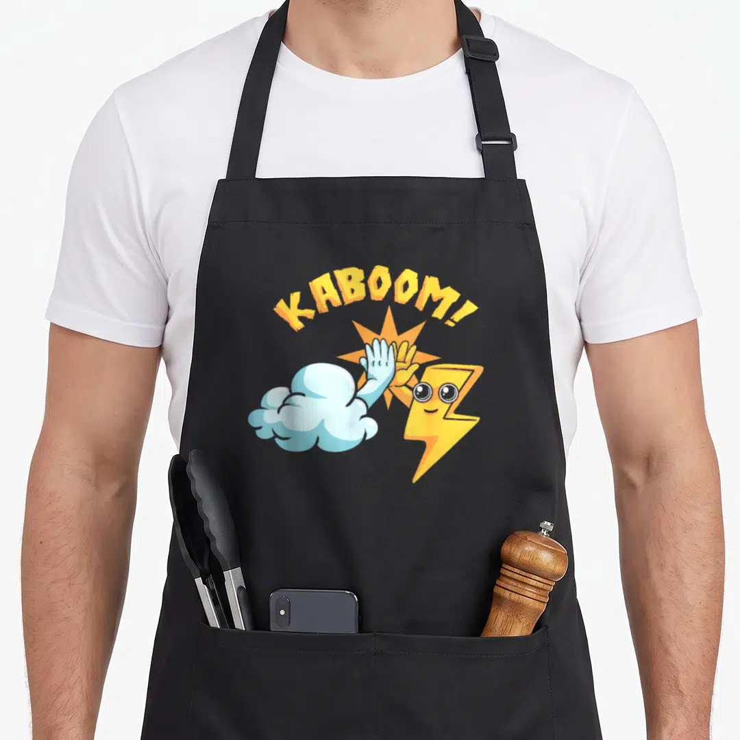 Weather thunderstorms apron - Cartoon cloud and lightning bolt high-fiving under arched yellow KABOOM! text with orange — shown on a black cotton canvas apron against a white background