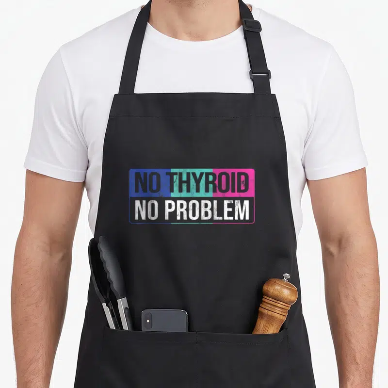 Problem thyroid apron - NO THYROID NO PROBLEM text in blue teal pink rectangular frame — shown on a black cotton canvas apron against a white background