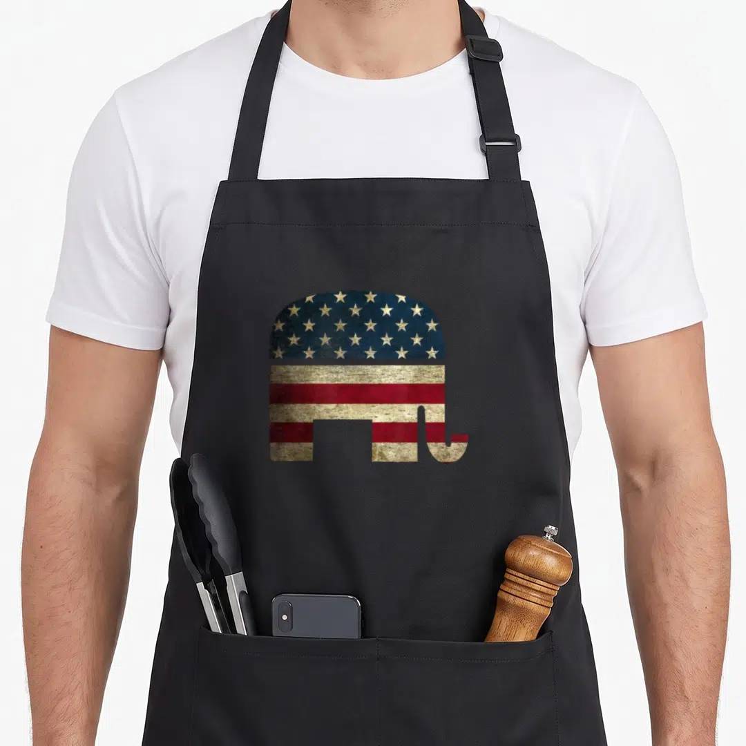 Patriotic elephant print apron - Distressed elephant silhouette filled with blue stars and red white stripes — shown on a black cotton canvas apron against a white background