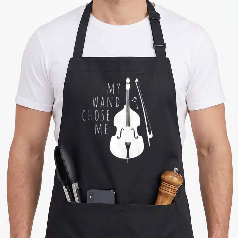 Cello double apron - White double bass and bow with stacked text My Wand Chose Me — shown on a black cotton canvas apron against a white background