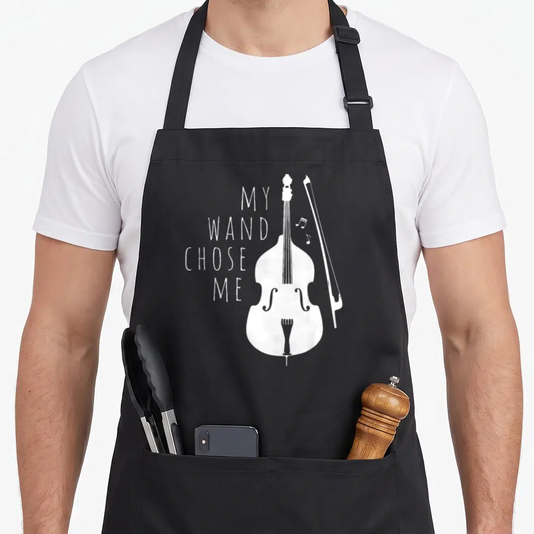 Cello double apron - White double bass and bow with stacked text My Wand Chose Me — shown on a black cotton canvas apron against a white background