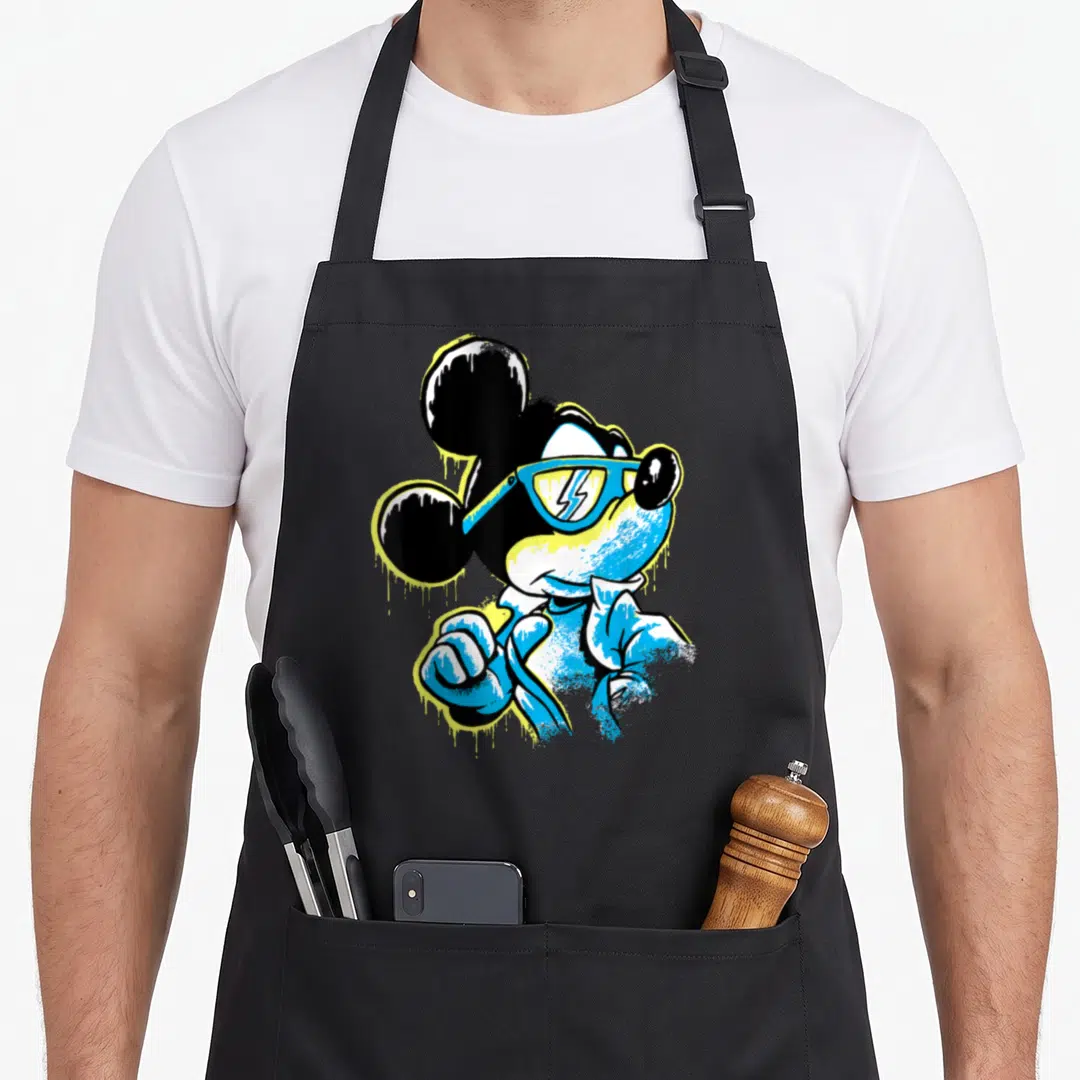 Icy drip apron - Stylized Mickey Mouse in blue sunglasses with yellow paint drip effects on black ears — shown on a black cotton canvas apron against a white background