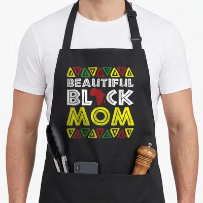 Melanin beautiful apron - BEAUTIFUL BLACK MOM text with red Africa map and geometric triangle borders — shown on a black cotton canvas apron against a white background