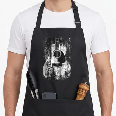 Acoustic distressed apron - Black and white distressed acoustic guitar with splattered paint effect — shown on a black cotton canvas apron against a white background