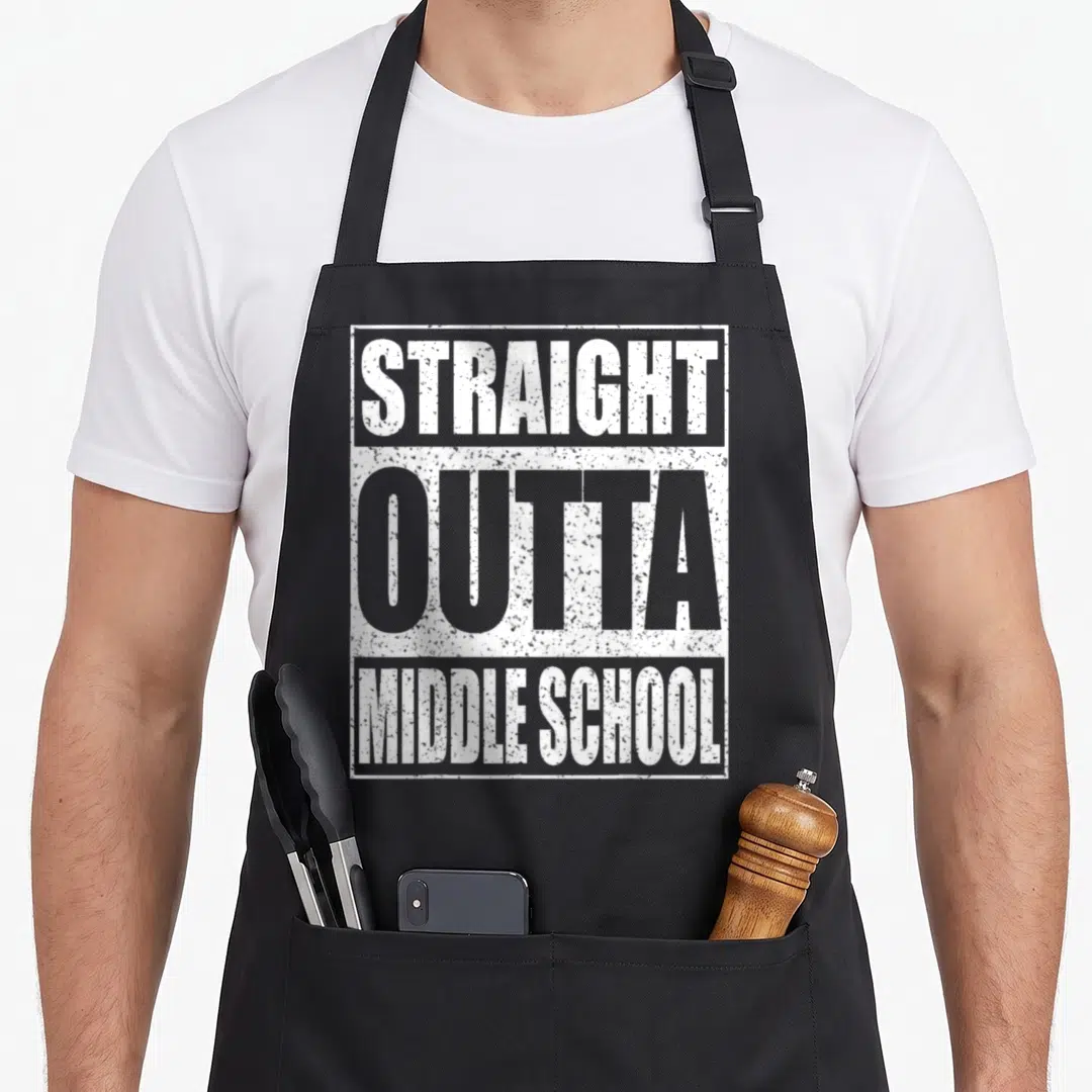 Outta school graduation apron - White stacked text reading STRAIGHT OUTTA MIDDLE SCHOOL inside a rectangular border — shown on a black cotton canvas apron against a white background