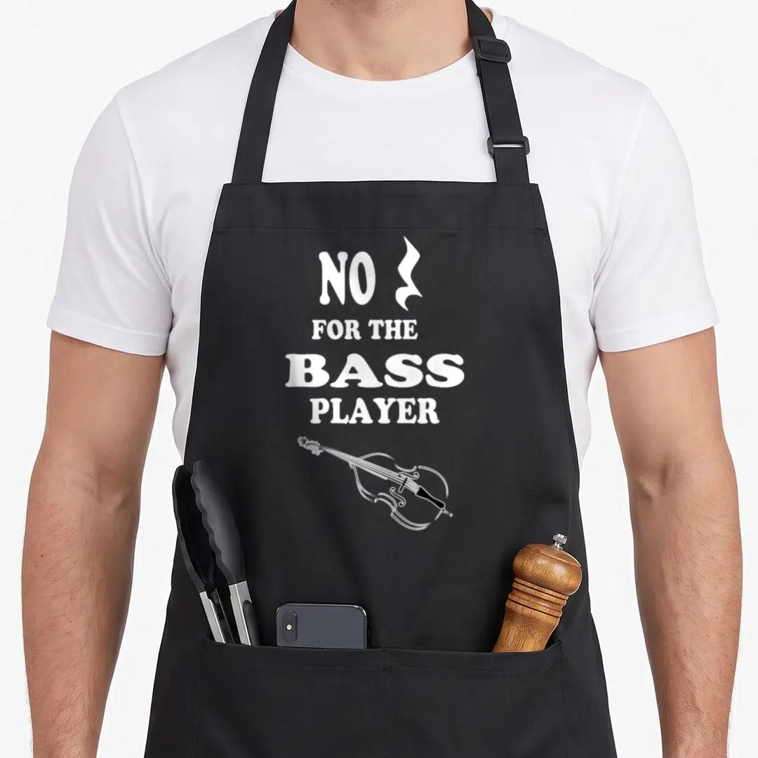 Upright double apron - White stacked text NO FOR THE BASS PLAYER above a bass guitar outline on black background — shown on a black cotton canvas apron against a white background