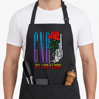 Pistol gun apron - G.N.R text with red rose and silver revolver over distressed background — shown on a black cotton canvas apron against a white background