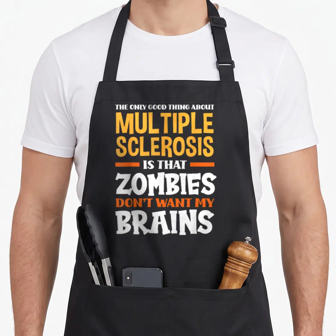 Multiple magpie mom apron - White and orange stacked text reading The Only Good Thing About Multiple Sclerosis Is That — shown on a black cotton canvas apron against a white background