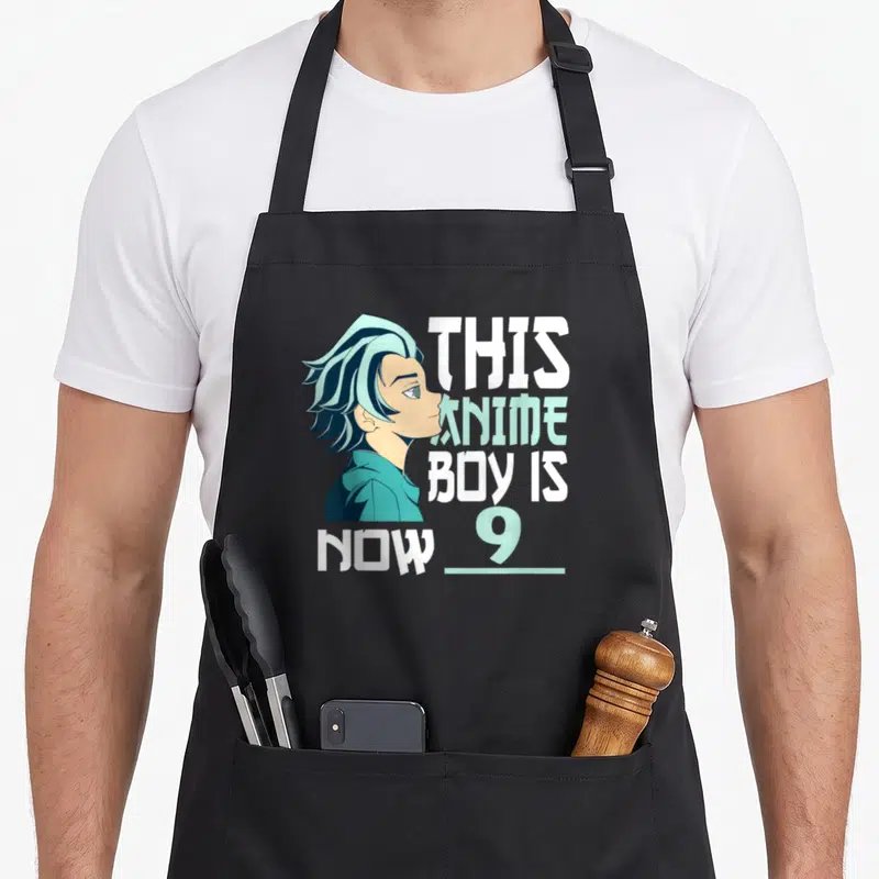 Manga birthday anime mom apron - Anime boy profile with stacked text This Anime Boy is Now 9 in teal and white — shown on a black cotton canvas apron against a white background