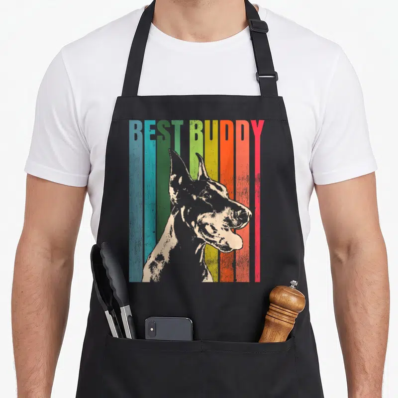 Pinscher dobie dog apron - Retro graphic of a dog profile over vertical stripes with BEST BUDDY text — shown on a black cotton canvas apron against a white background