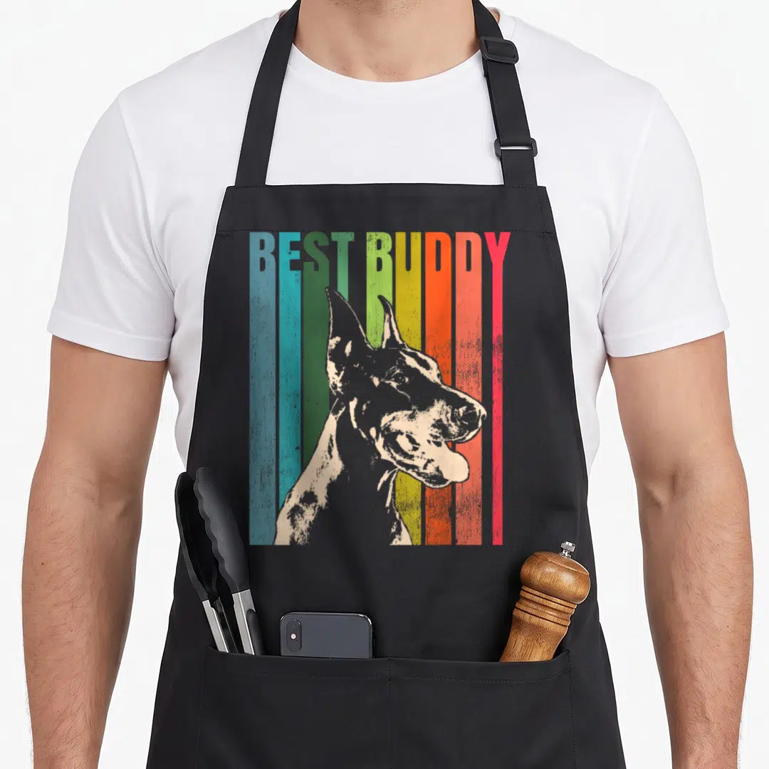 Pinscher dobie dog apron - Retro graphic of a dog profile over vertical stripes with BEST BUDDY text — shown on a black cotton canvas apron against a white background