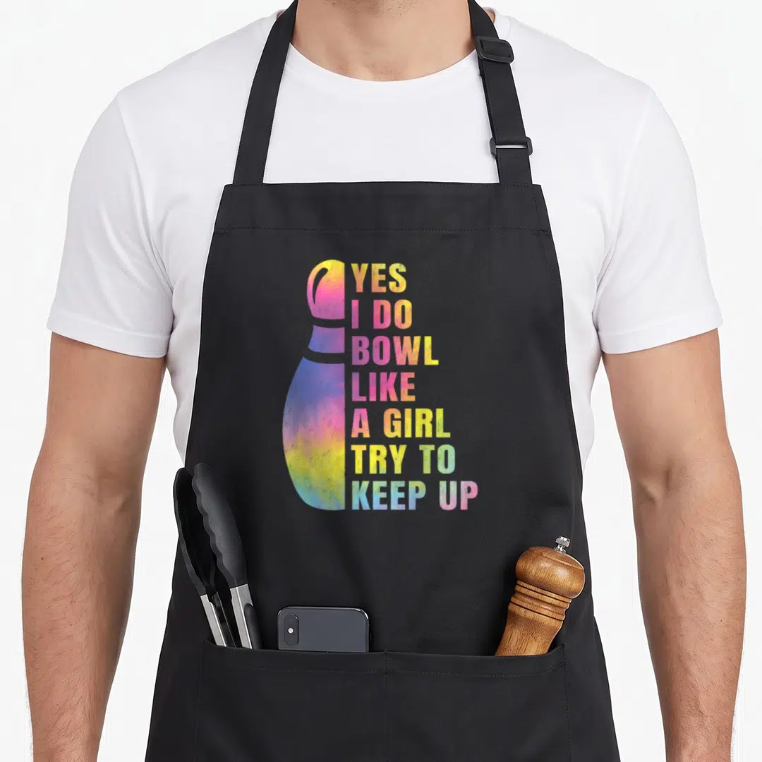 Bowl bowling team co apron - Tie-dye bowling pin with stacked text Yes I Do Bowl Like A Girl Try To Keep Up — shown on a black cotton canvas apron against a white background