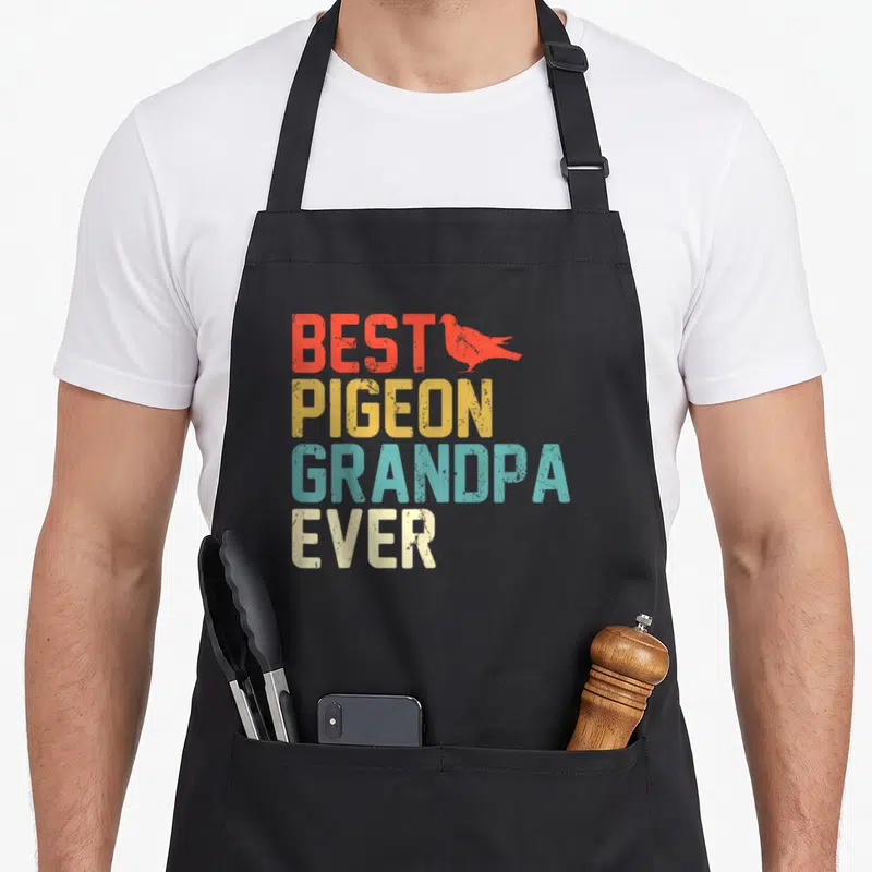 Grandpa bird apron - Stacked distressed text BEST PIGEON GRANDPA EVER with red pigeon silhouette — shown on a black cotton canvas apron against a white background