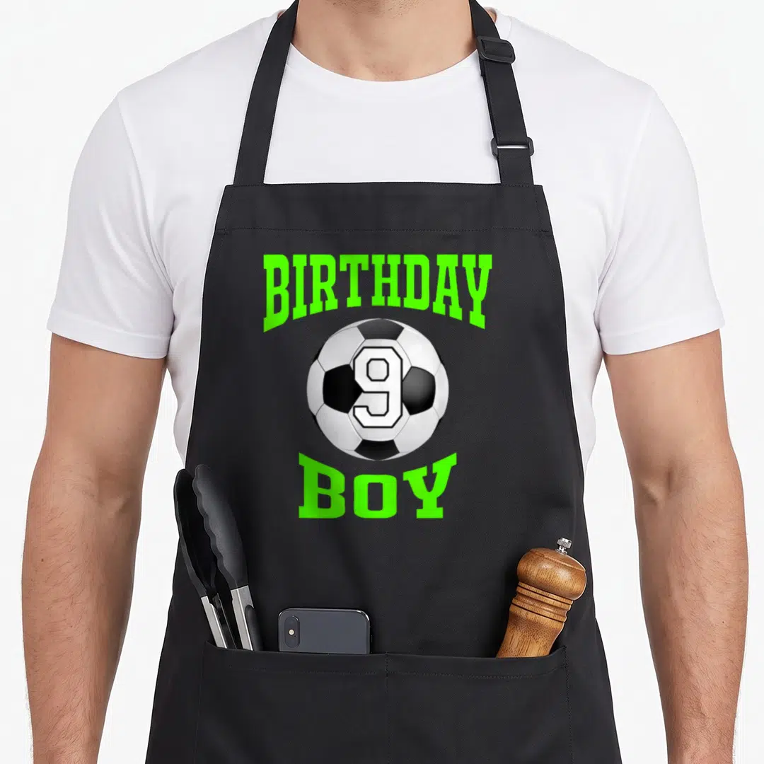 Funny 9th birthday apron - Soccer ball with number 9 flanked by lime green BIRTHDAY BOY text — shown on a black cotton canvas apron against a white background