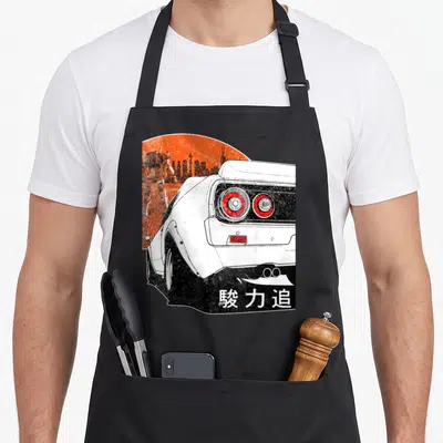 Jdm racing apron - White car rear view, orange sun, robot silhouette, black skyline, kanji text — shown on a black cotton canvas apron against a white background