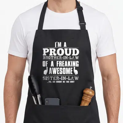 Sister in laws apron - Stacked white text reading I'm a proud brother-in-law with two thumbs up hands — shown on a black cotton canvas apron against a white background