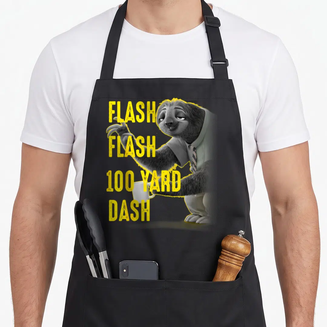 Flash yard apron - Sloth holding mug next to stacked yellow text reading FLASH 100 YARD DASH — shown on a black cotton canvas apron against a white background