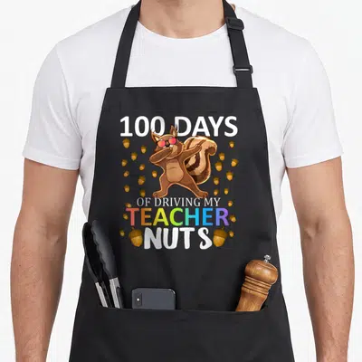Driving teacher apron - Dabbing squirrel with sunglasses and 100 Days Of Driving My Teacher Nuts text surrounded — shown on a black cotton canvas apron against a white background